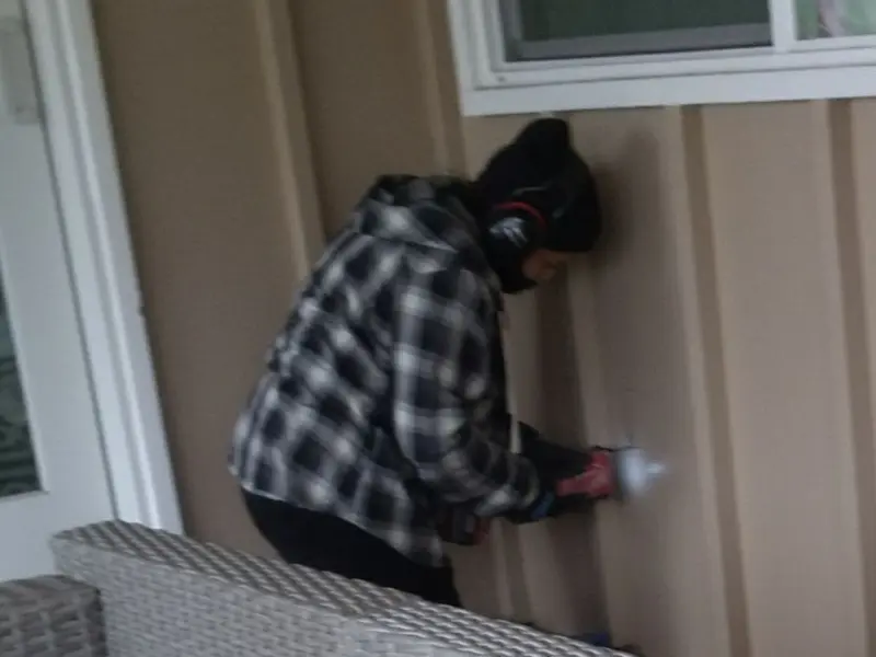 Professional electrician installing an exterior outlet in Buffalo