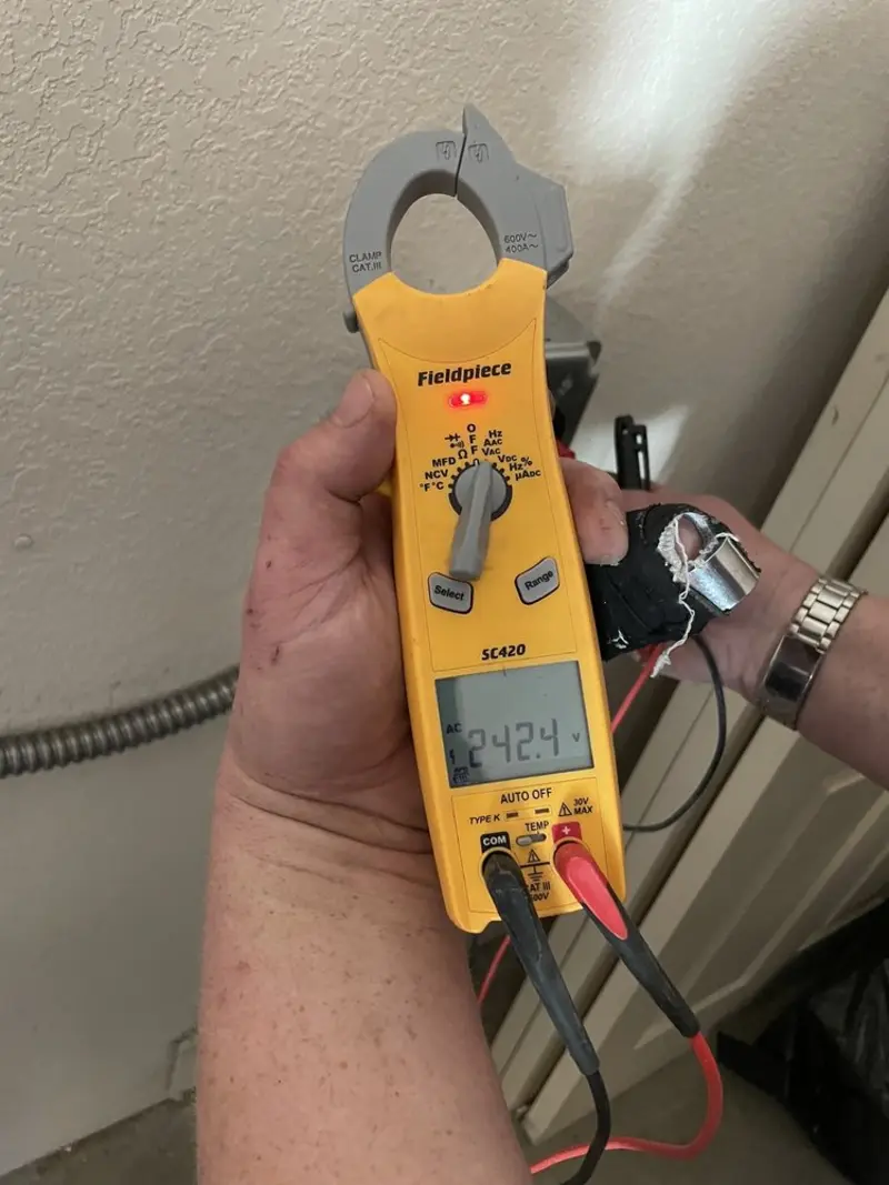 Voltage testing with clamp meter during Outlet Installation in Buffalo